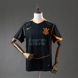 Camisola SC Corinthians 2025-26 Alternativa Preta/Laranja Versão Adepto Todos Patrocinadores