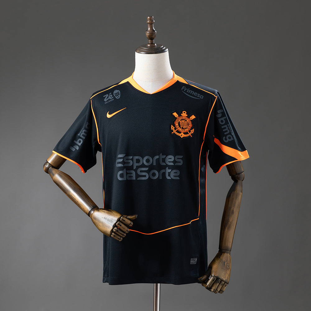 Camisola SC Corinthians 2025-26 Alternativa Preta/Laranja Versão Adepto Todos Patrocinadores